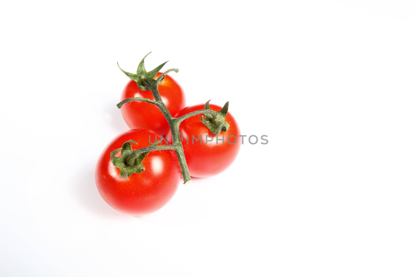 three cherry tomatoes on white background by diecidodici