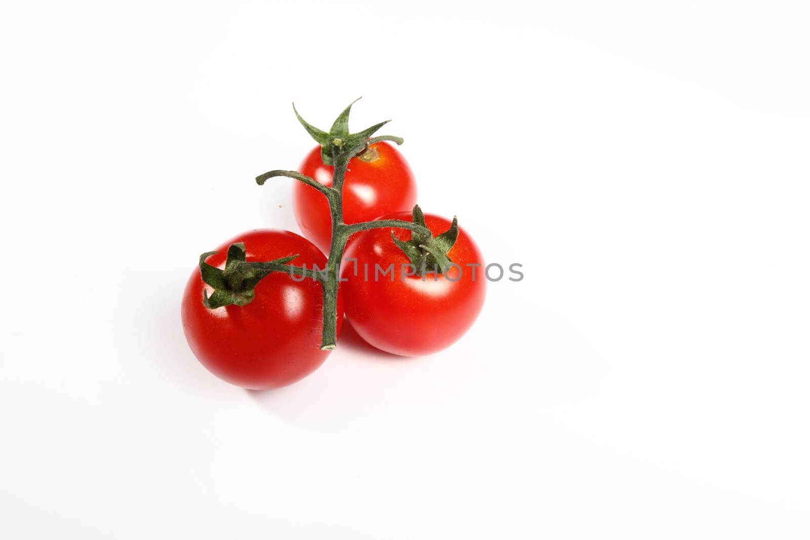 three cherry tomatoes on white background