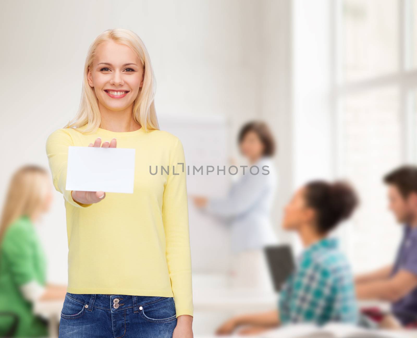 smiling girl with blank business or name card by dolgachov