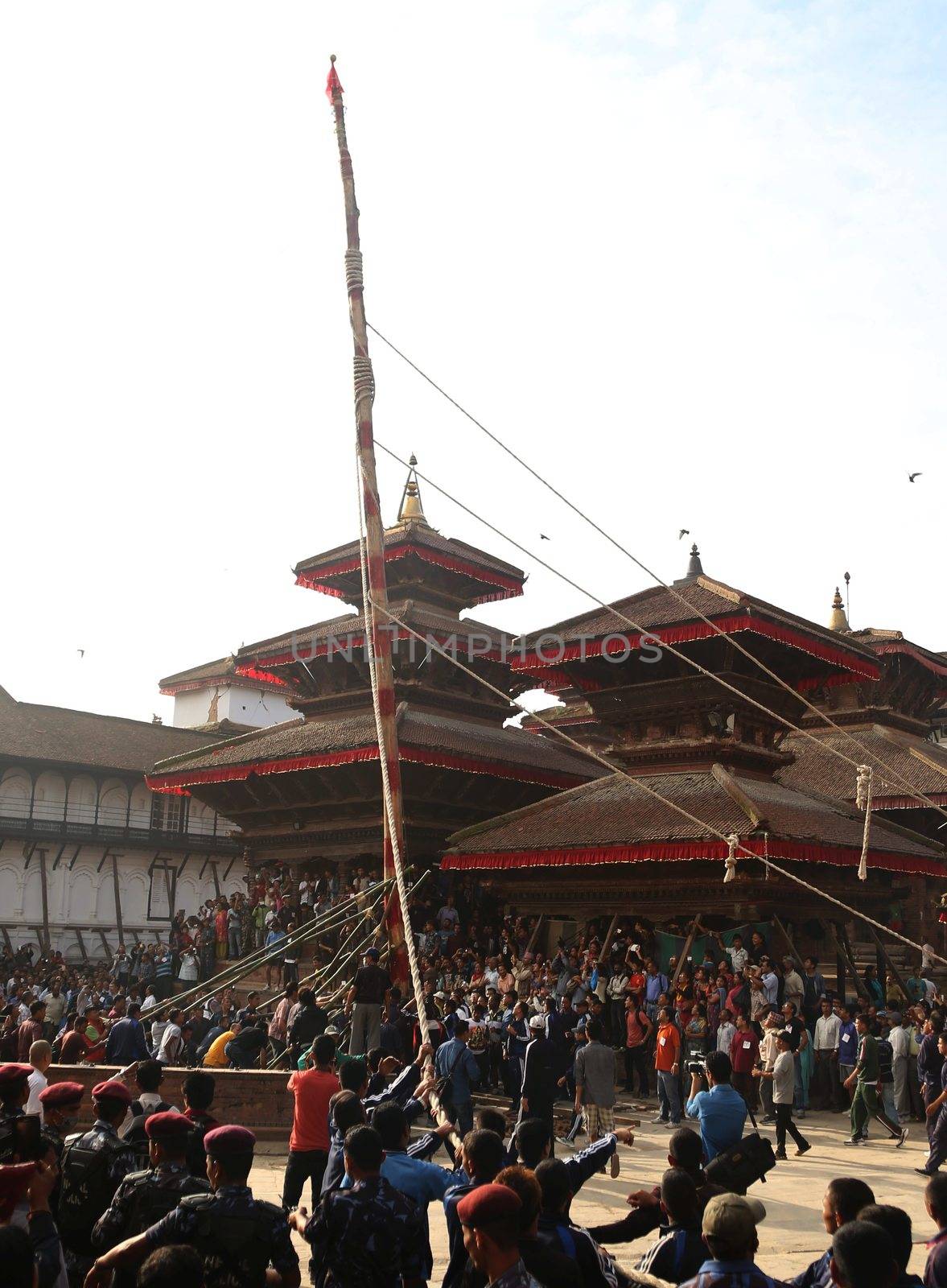 NEPAL, Kathmandu:  	The erection of a wooden Indradhoj pole in Hanumandhoka�Durbar Square on September 25, 2015 marked the beginning of Indrajatra festival in Kathmandu, Nepal.  	Indrajatra is an eight day festival with a chariot procession dedicated to Goddess Kumari, Lord Ganesh and Bhairav, as well as worshiping Indra, the king of gods. 