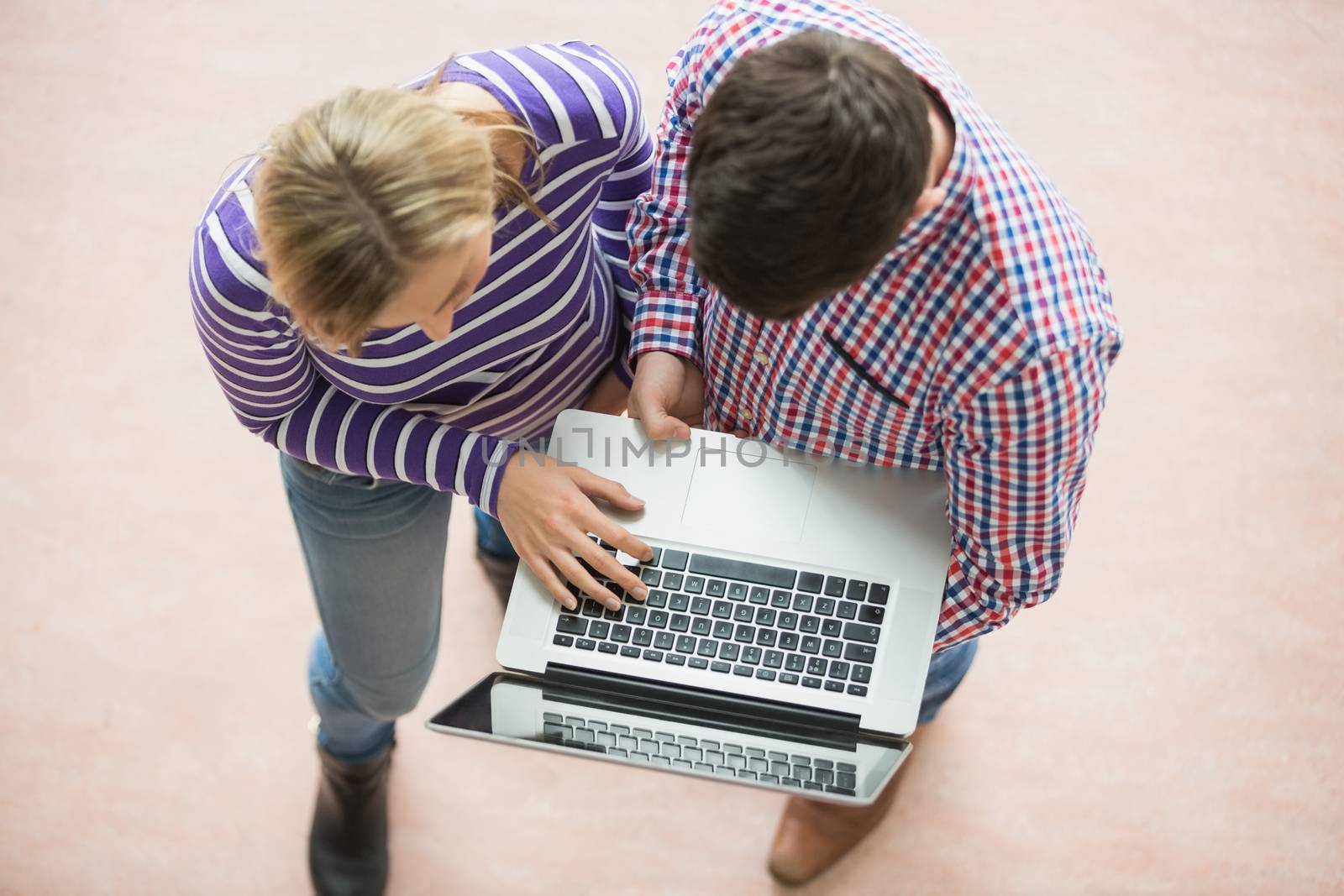 High angle view of college students working on laptop