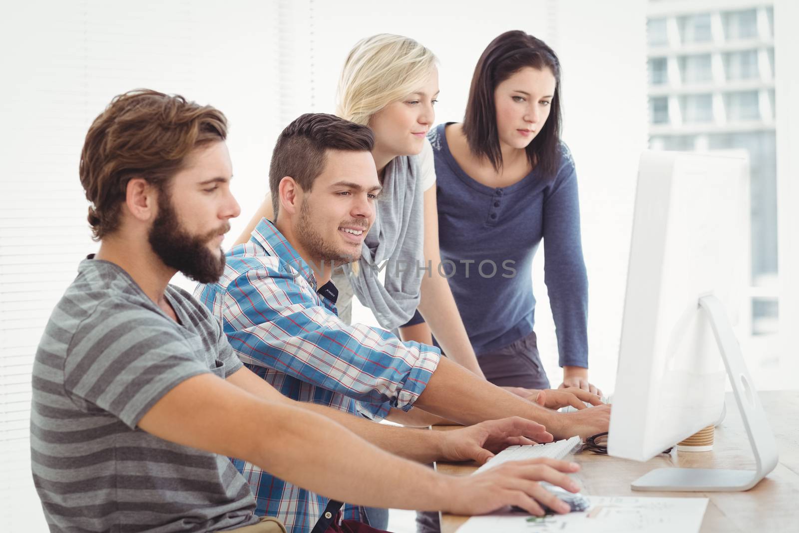 Business team working on computer  by Wavebreakmedia