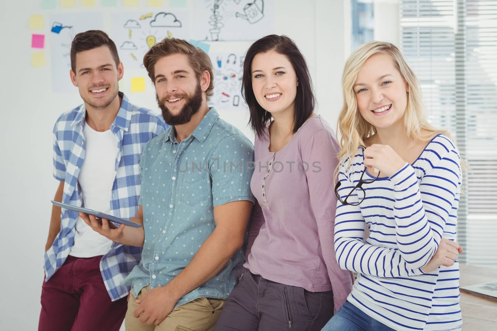 Portrait of smiling business team at creative office