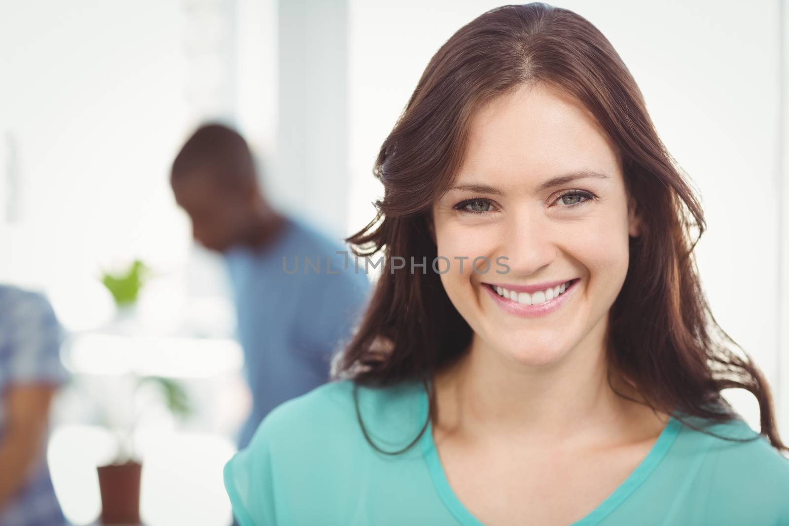 Portrait of smiling woman  by Wavebreakmedia