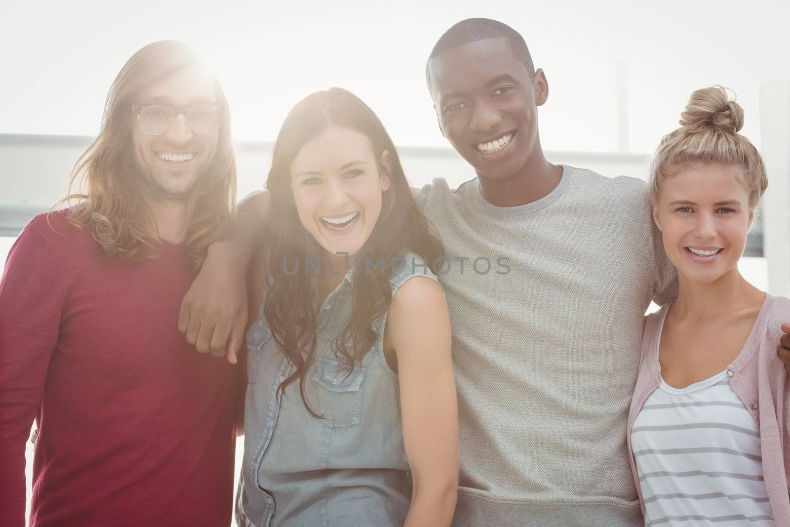 Portrait of smiling people with arms around