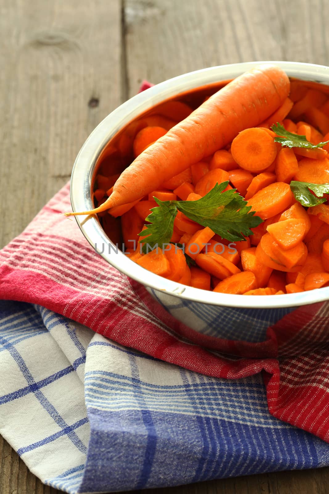 chopped carrots in bowl of steel , shallow dof 