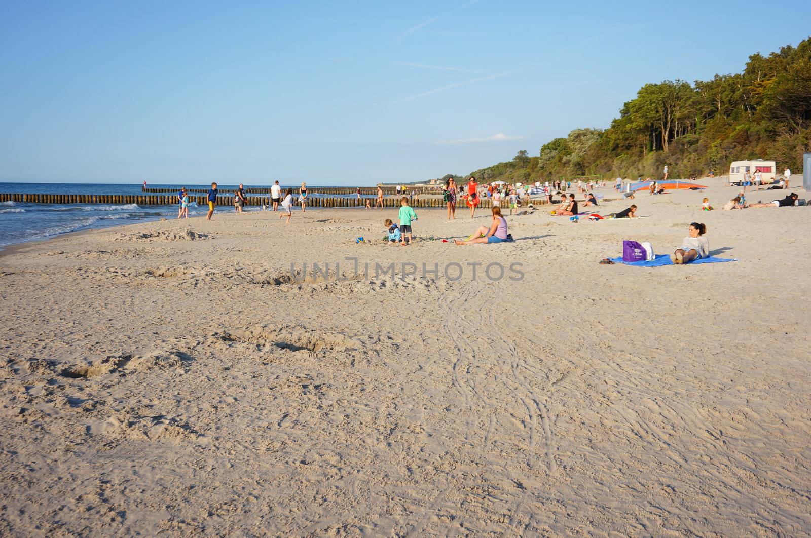 SIANOZETY, POLAND - JULY 18, 2015: Sand and people at a beach with forest 
