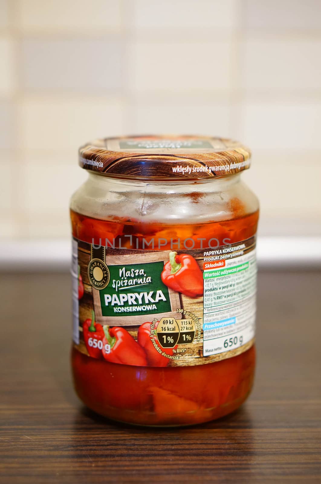 POZNAN, POLAND - SEPTEMBER 24, 2015: Red pepper in a glass jar standing on table