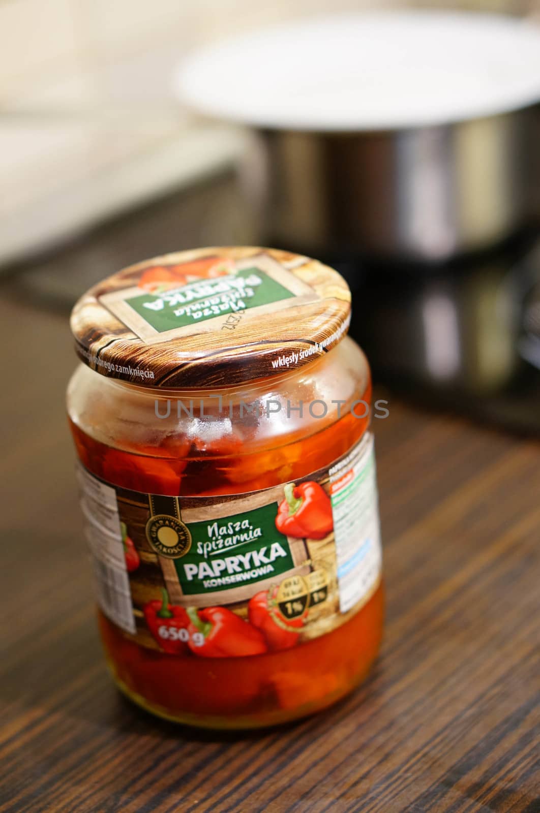 POZNAN, POLAND - SEPTEMBER 24, 2015: Red pepper in a glass jar standing on table