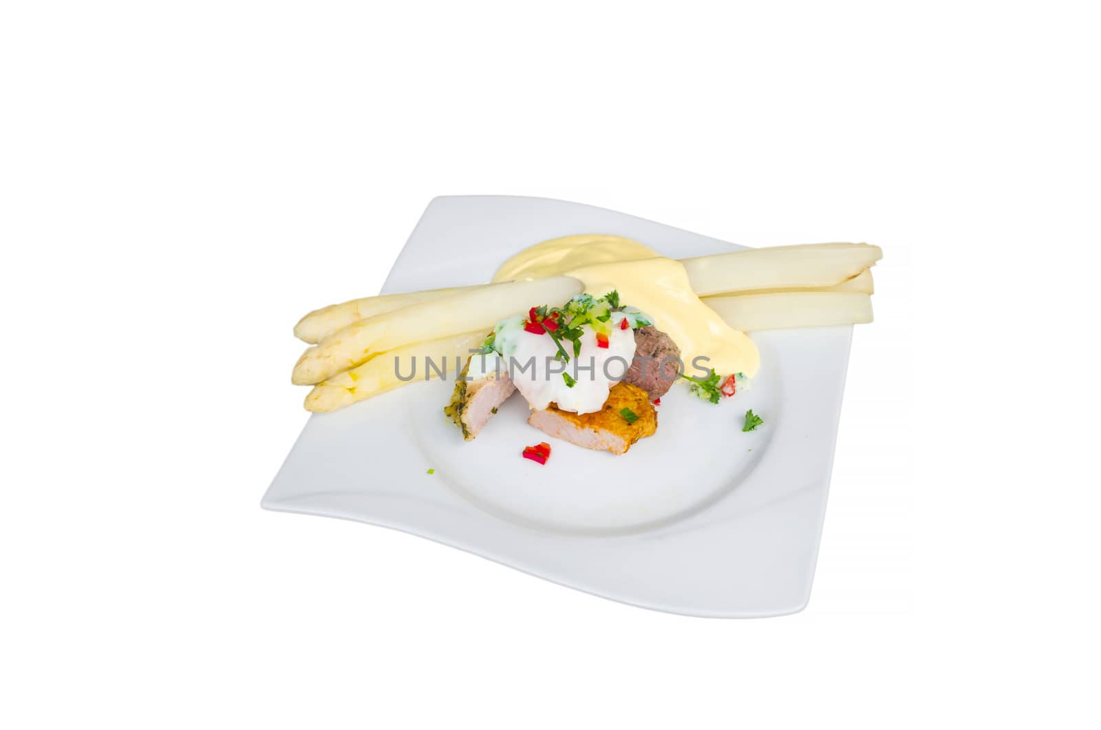 White asparagus with salad on pork and beef fillet. Isolated. Tradition German food. View from above.