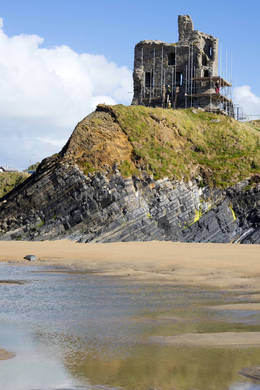 ballybunion castle with scafolding on cliff by morrbyte