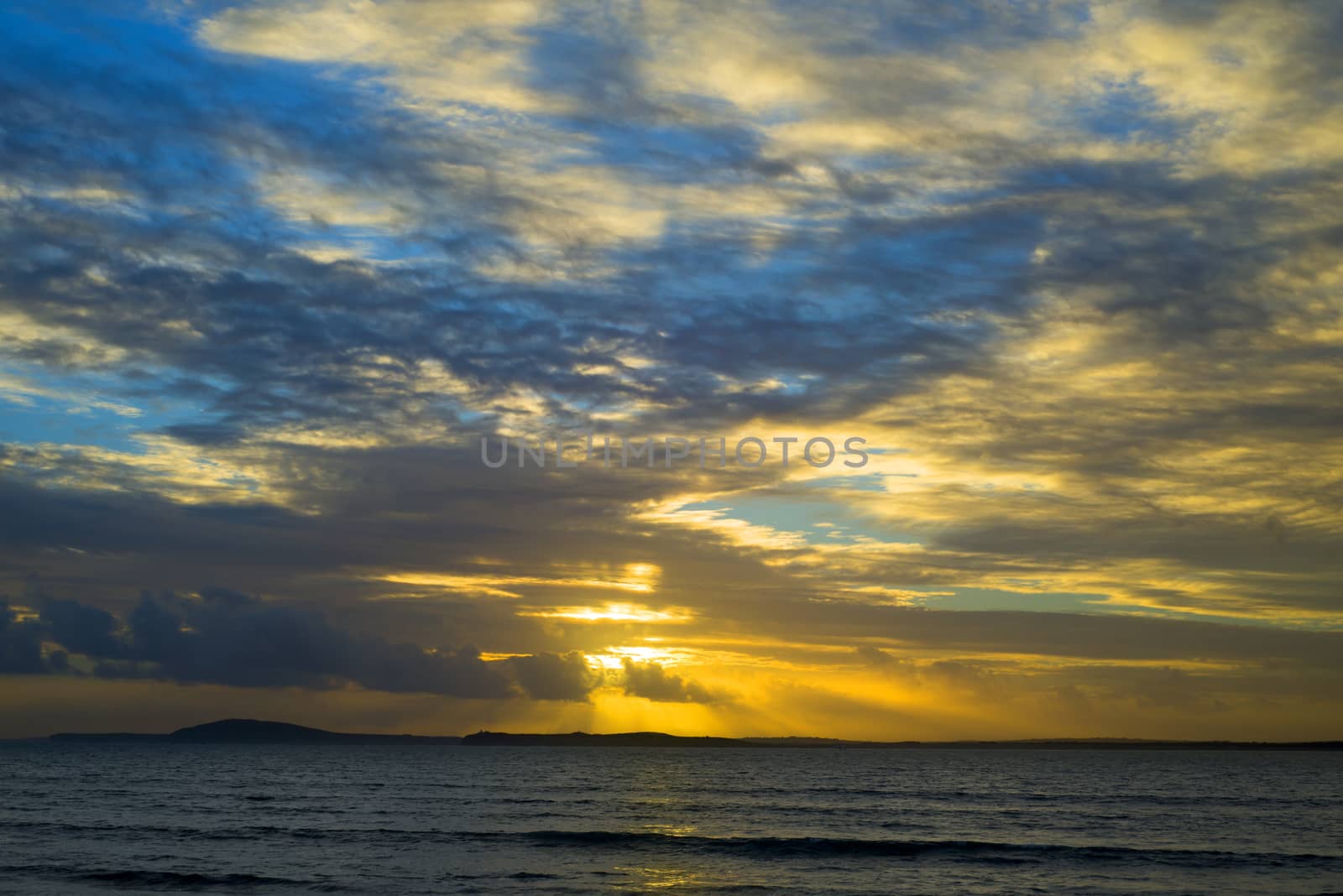 beal beach rocks and seaweed sunset by morrbyte