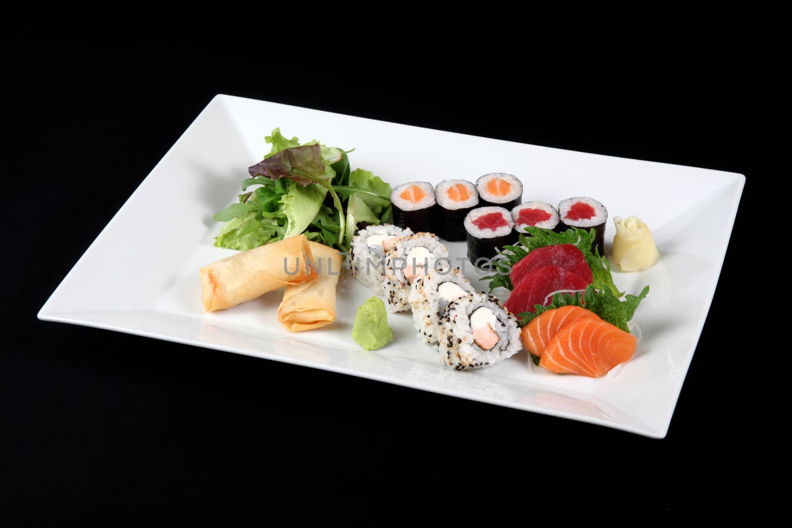 menu of sushi and sashimi with wasabi and vegetable in white plate on a black background