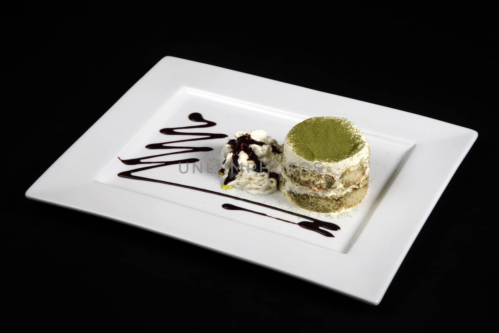 sweet green tea in white plate on a black background