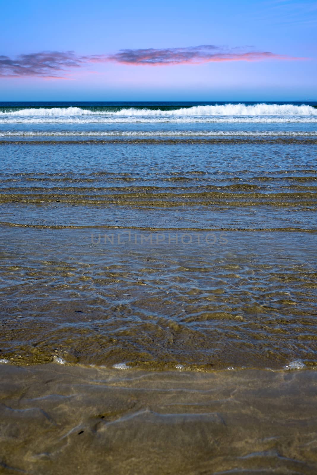 gentle soft waves lashing onto ballybunion beach by morrbyte