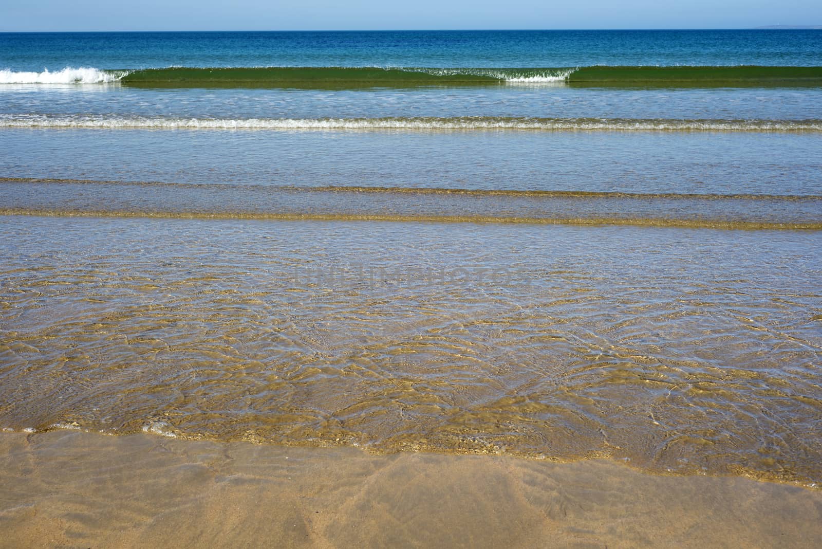 gentle soft waves lashing onto ballybunion sand by morrbyte