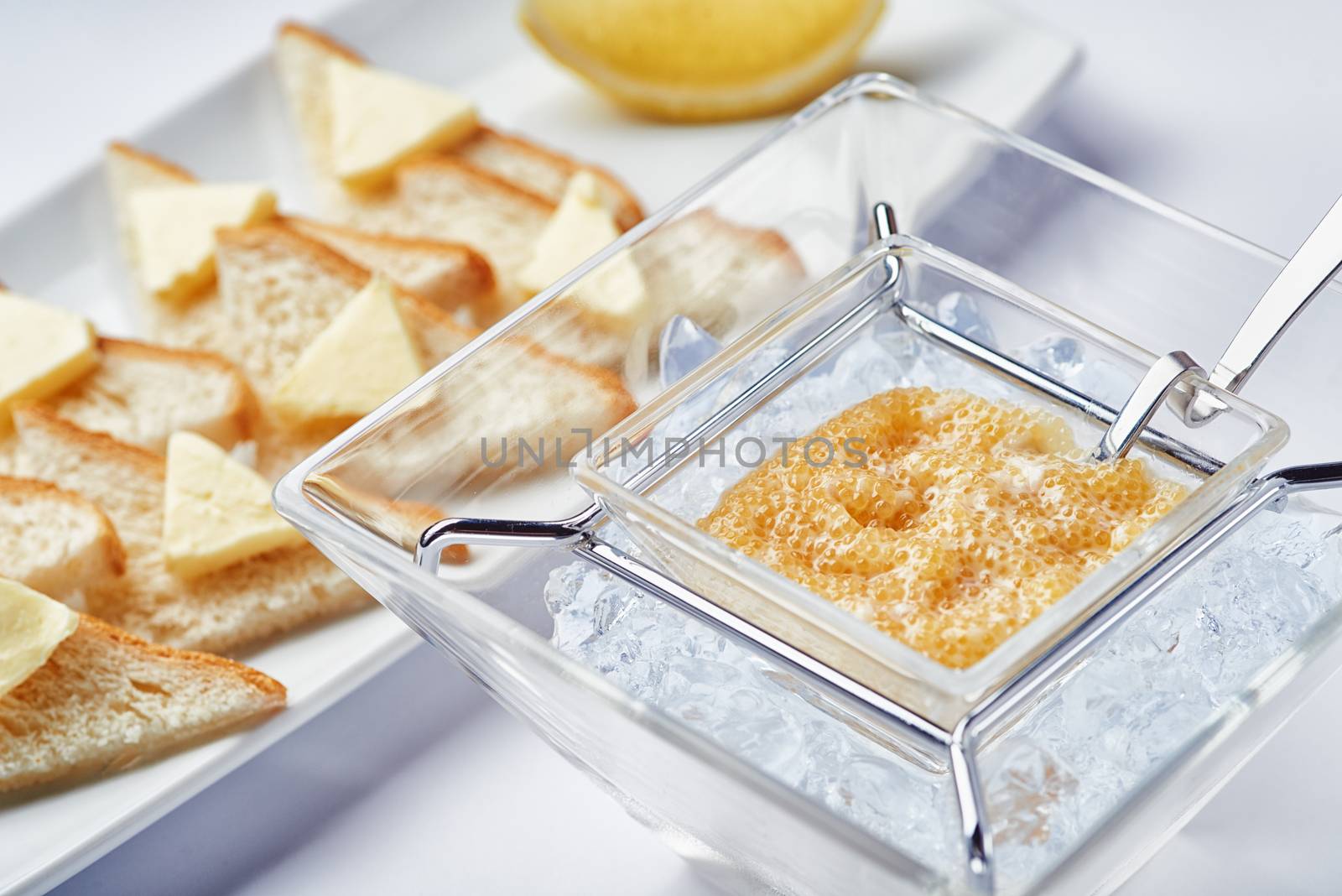 Breakfast fresh caviar on ice with toasts