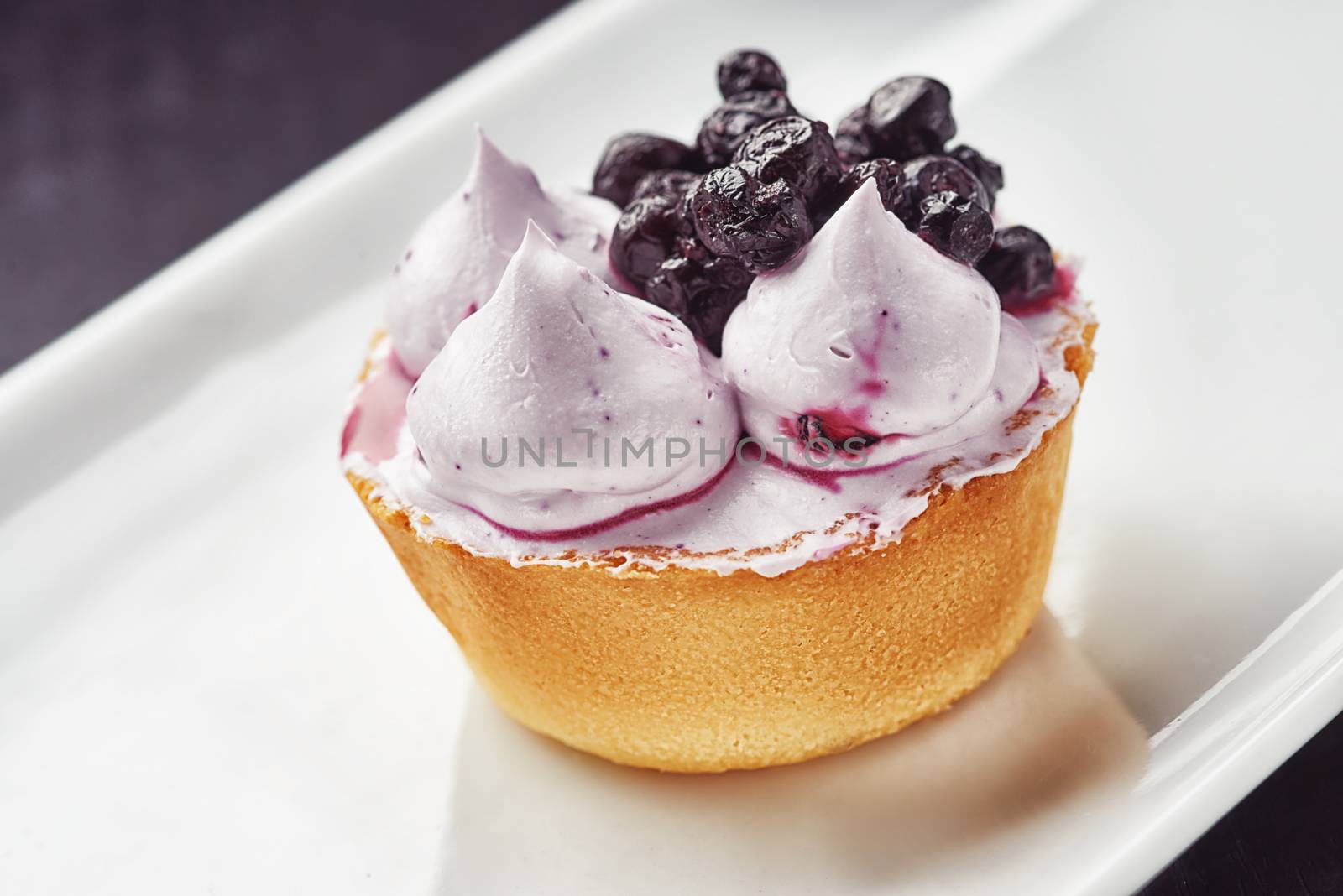 Beautiful cream Cupcake dessert with blackberry by shivanetua