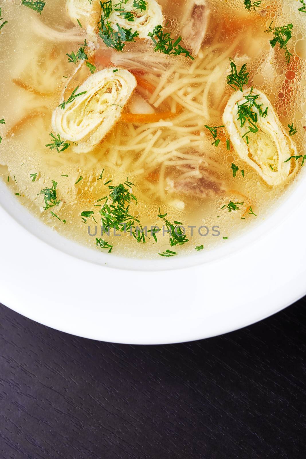 Clear chicken broth with vegetables and noodles