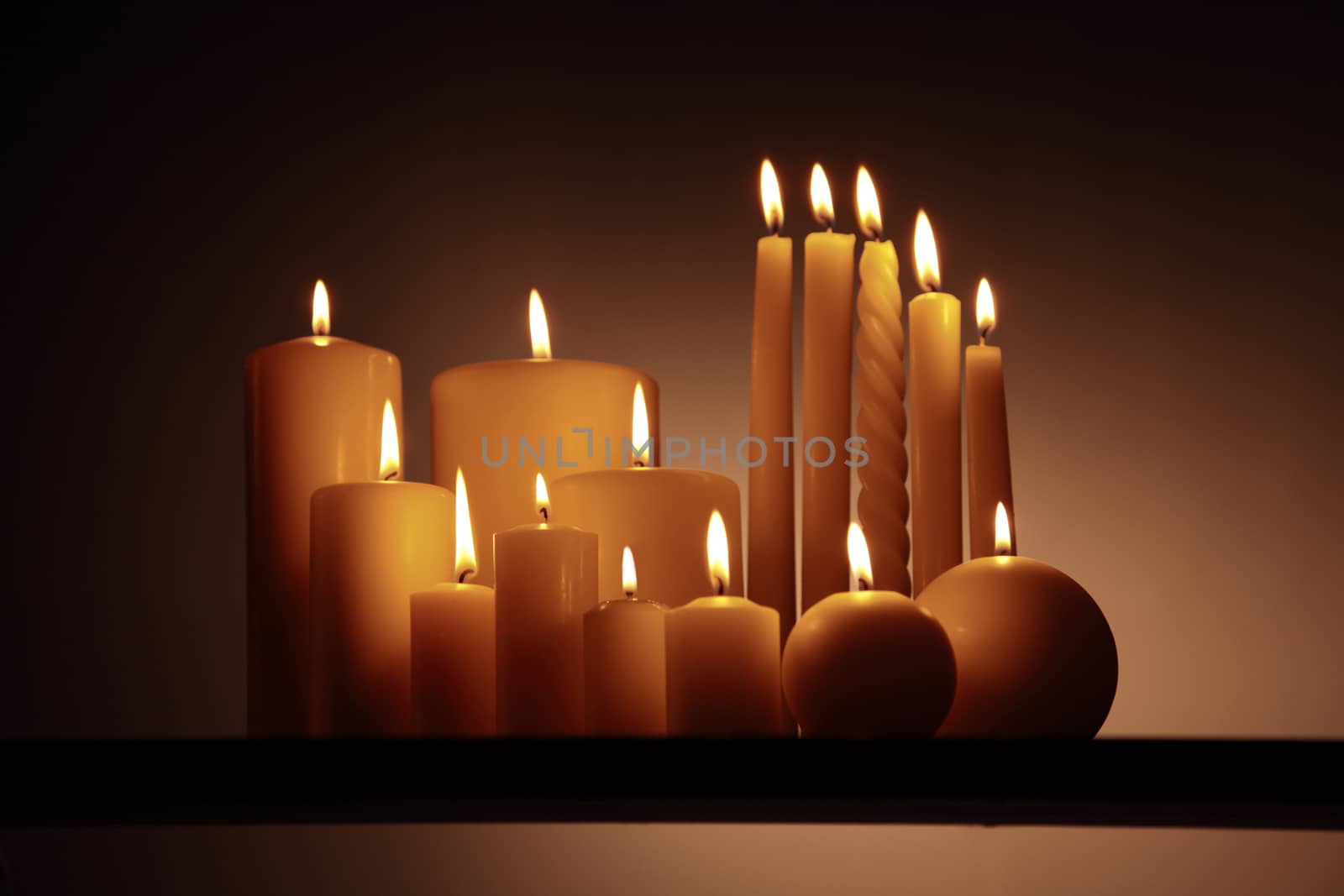 group 15 candles on wooden surface