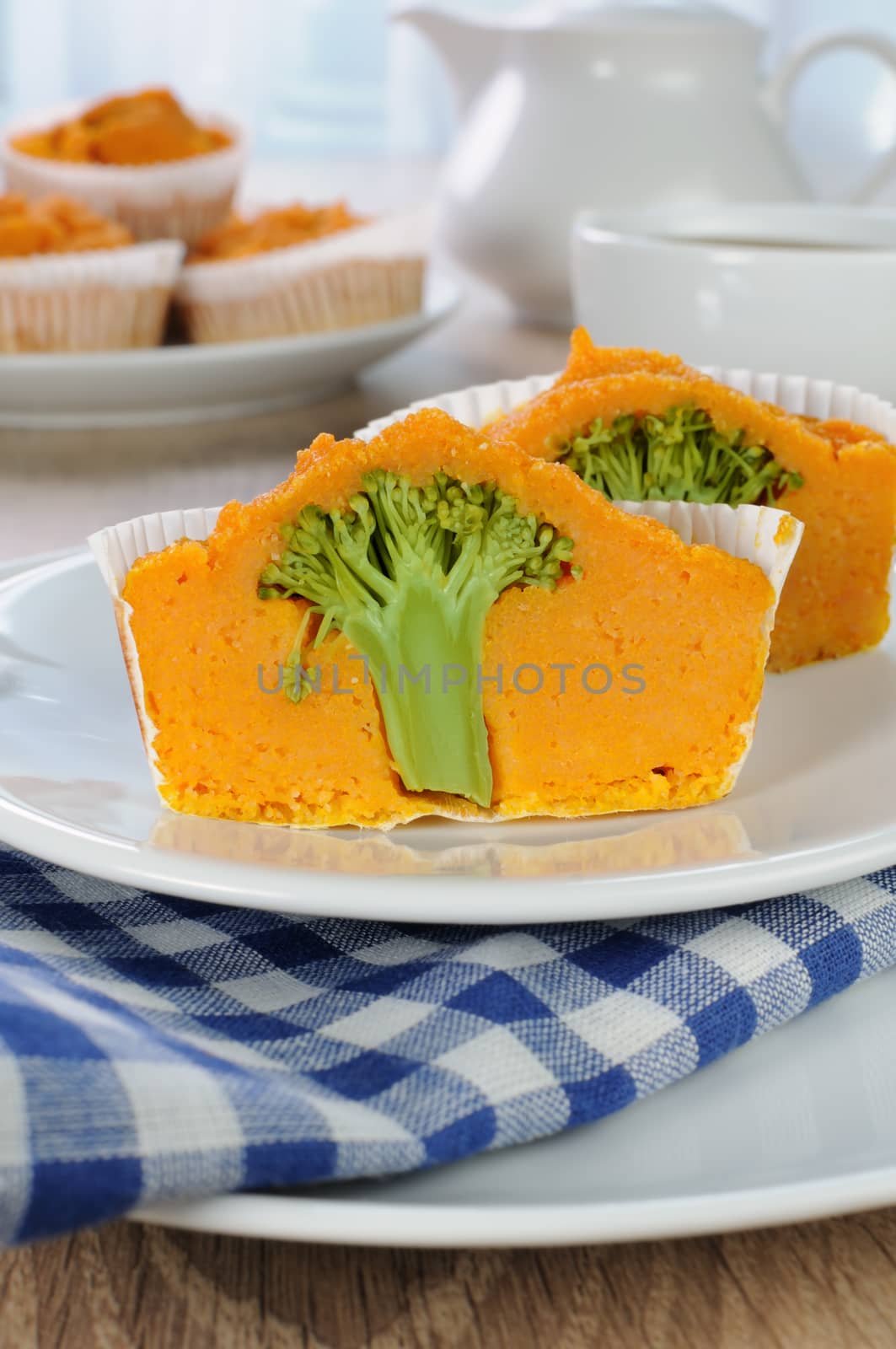 Pumpkin muffin with broccoli in a cut on a plate