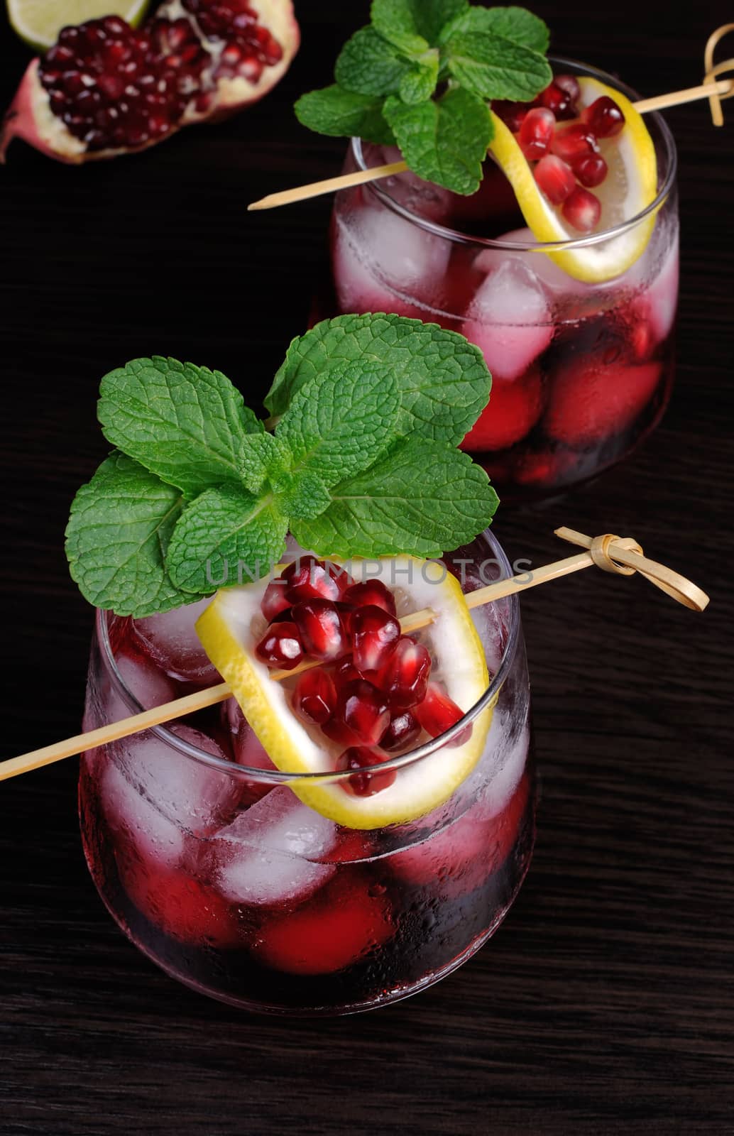pomegranate drink with ice, a slice of lemon and mint