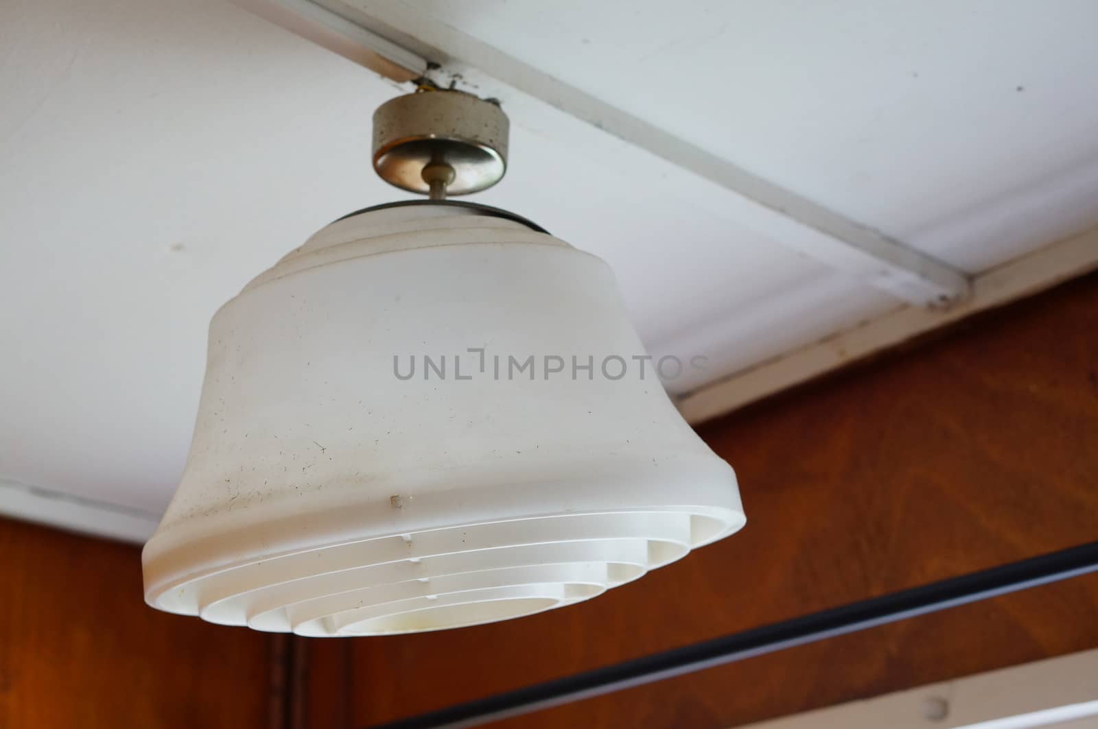 White plastic electric lamp hanging on ceiling 