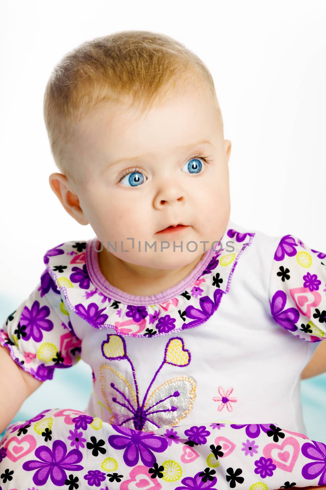 blue-eyed baby girl in a dress. Portrait. Close-up