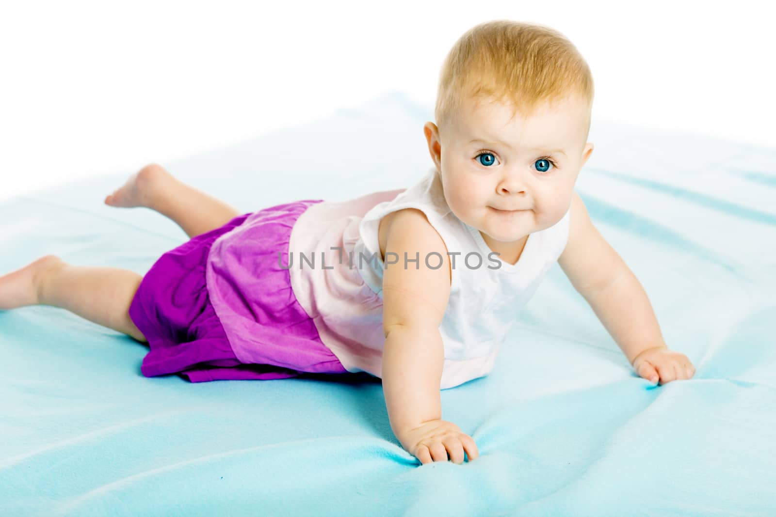 baby girl in a dress creeps on the blue coverlet by pzRomashka