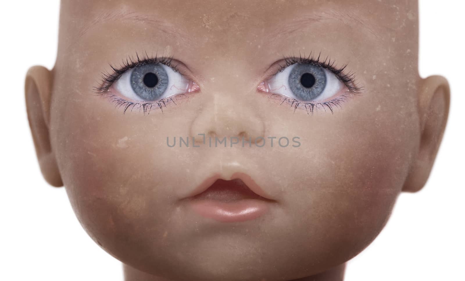 Scary doll face with human looking eyes