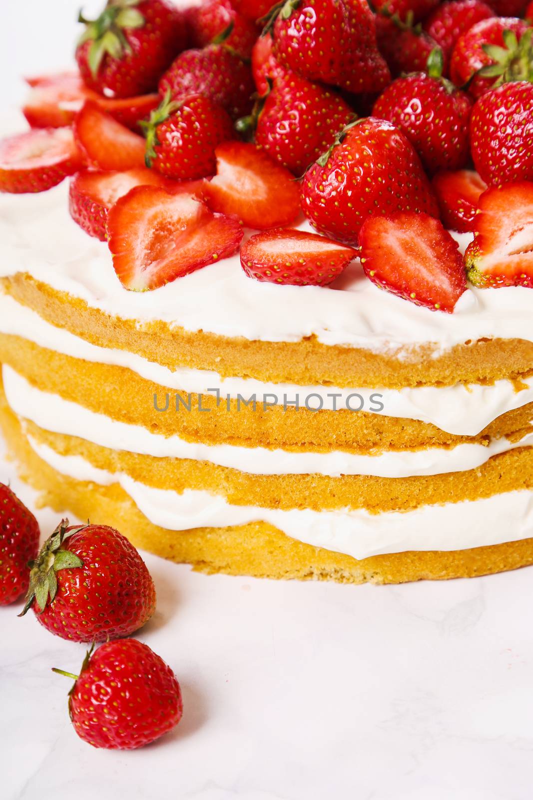 Layered, strawberry cake on the table
