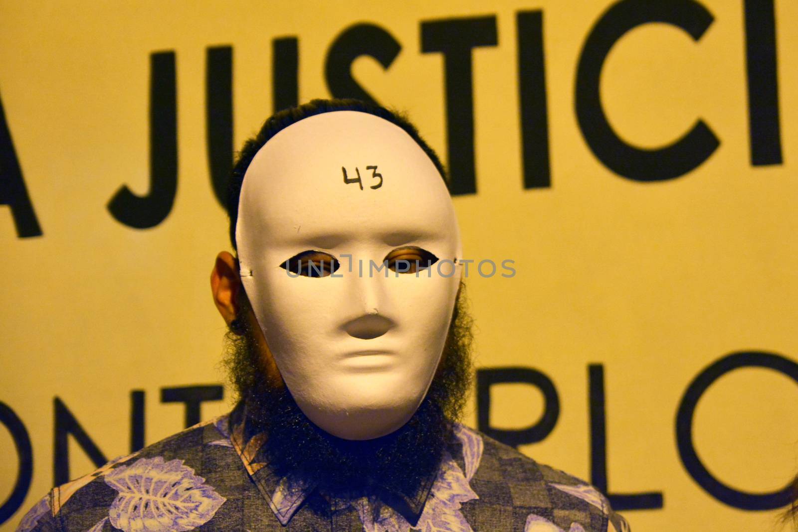 SPAIN, Madrid: A protester wearing a white mask attends a rally outside the Embassy of Mexico in Madrid, Spain on September 25, 2015, to remember the 46 missing Mexican students who disappeared in Iguala, Mexico on September 26 last year. The students who attended Ayotzinapa Rural Teachers' College went missing with the circumstances surrounding their disappearance still unclear