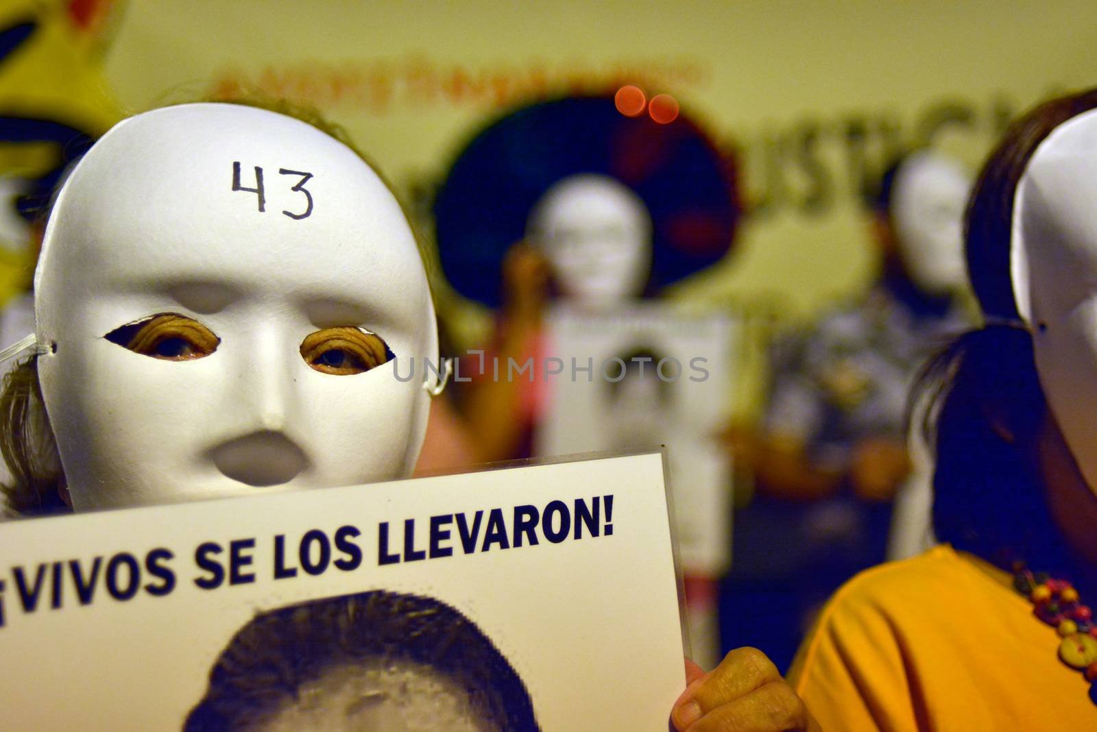 SPAIN, Madrid: A protester wearing a white mask attends a rally outside the Embassy of Mexico in Madrid, Spain on September 25, 2015, while holding up a sign displaying the photograph of a missing Mexican student who disappeared in Iguala, Mexico on September 26 last year. Forty-six students who attended Ayotzinapa Rural Teachers' College went missing with the circumstances surrounding their disappearance still unclear