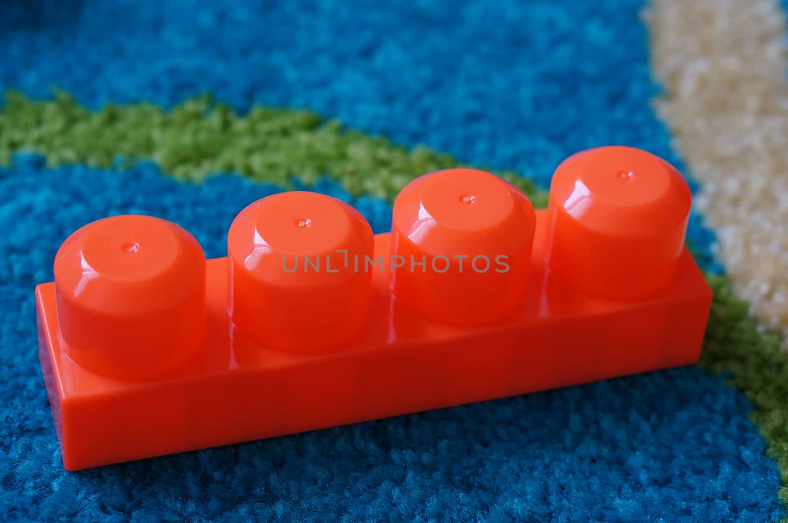 Red toy block with four pins