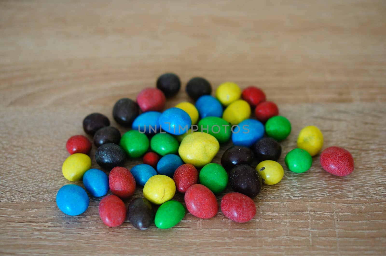 Chocolate peanuts mix on wooden background