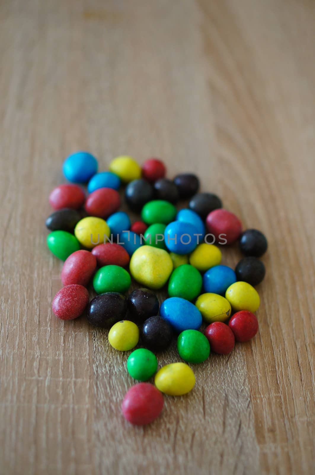 Chocolate peanuts mix on wooden background