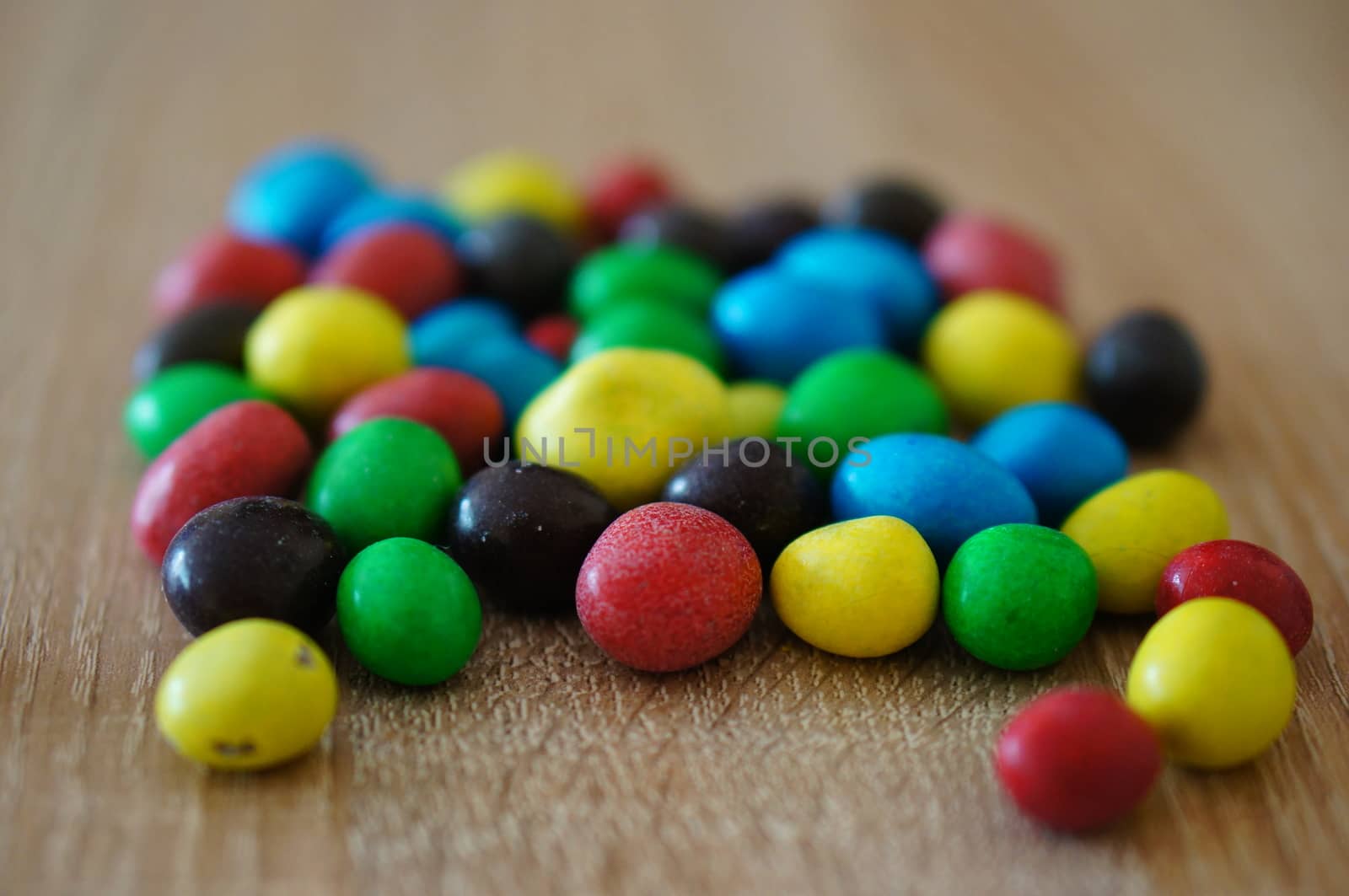 Chocolate peanuts mix on wooden background