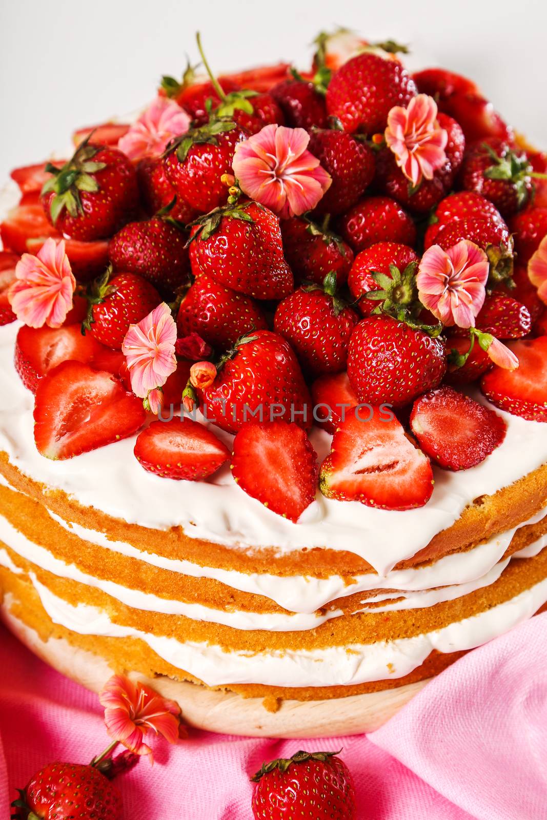 Layered, strawberry cake on the table