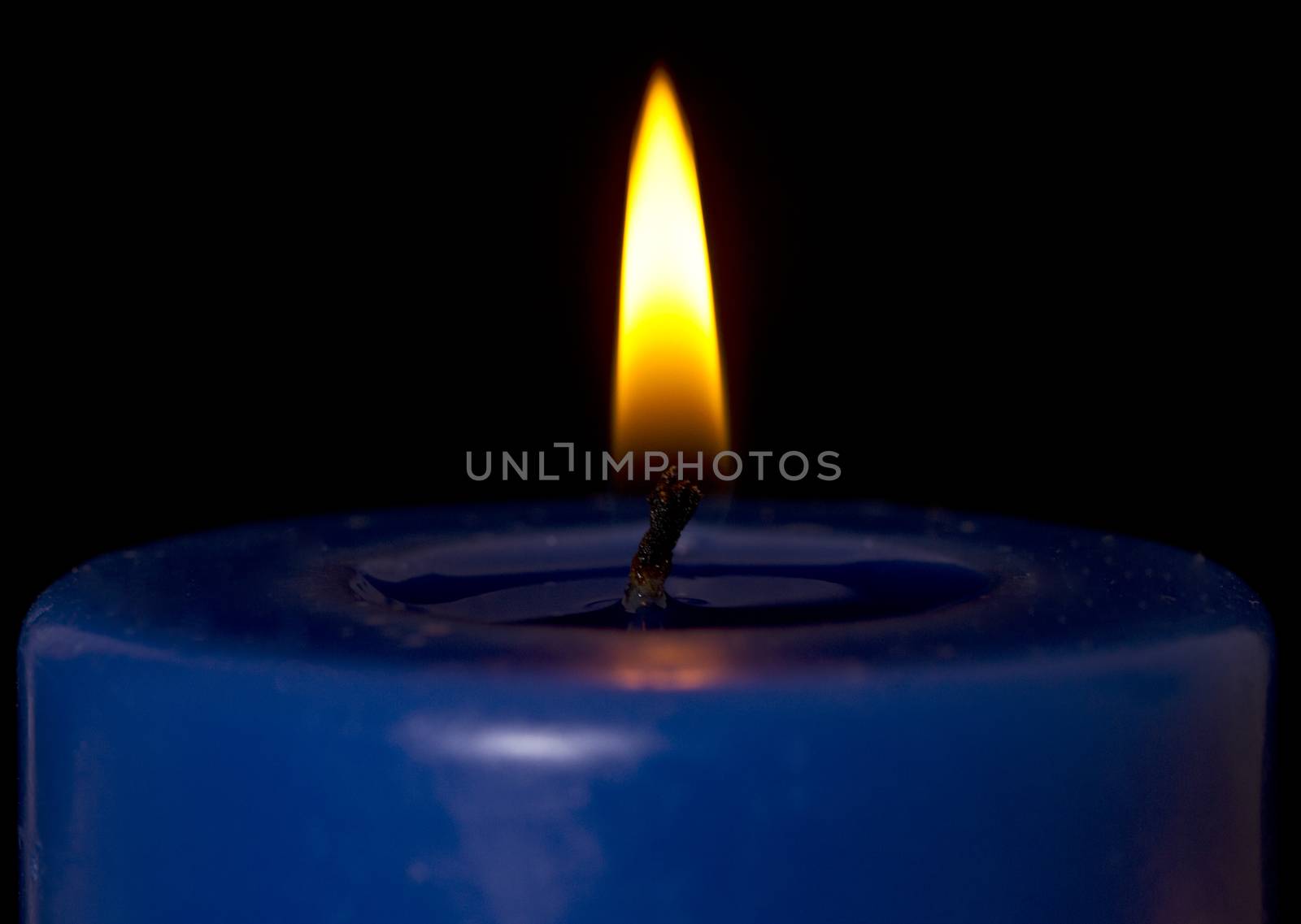 Macro shot of a single candle flame.