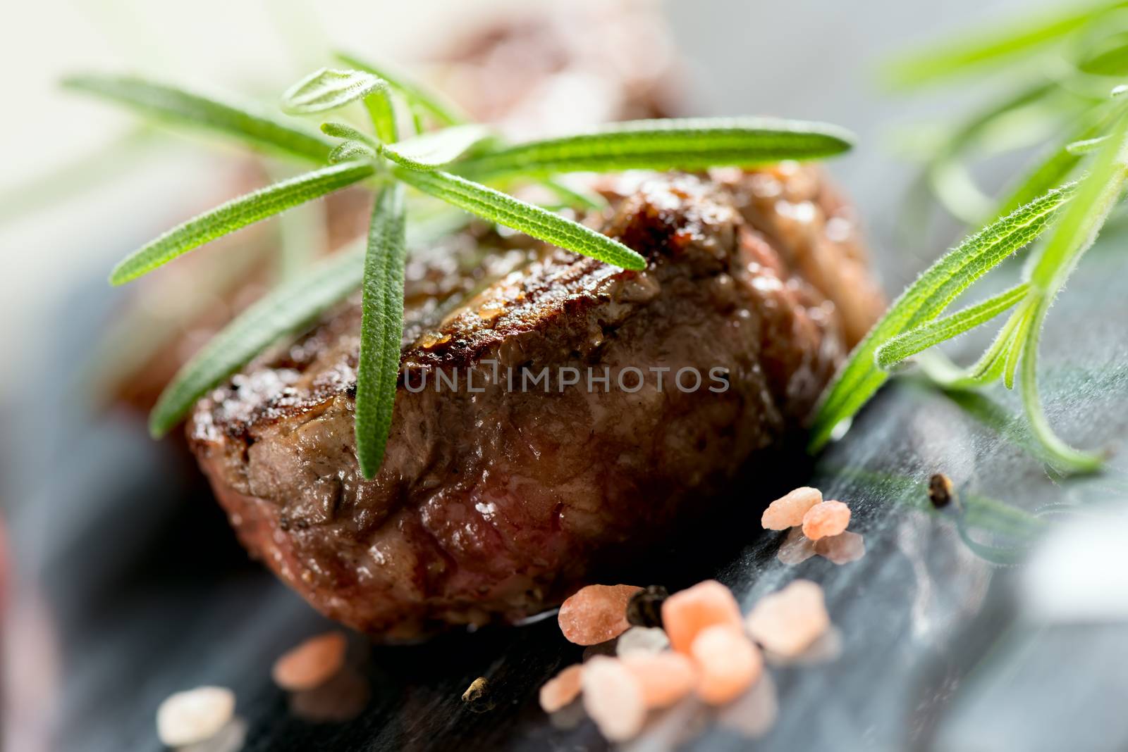 Grilled steak with rosemary closeup by Nanisimova