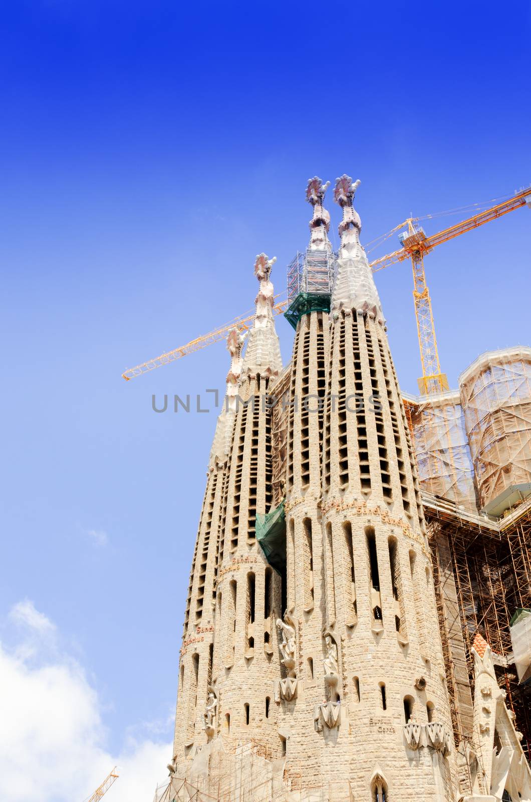 BARCELONA, SPAIN - JULY 13, 2012: The Basilica of La Sagrada Familia against blue sky.Fabulous creations of the great architect by Antoni Gaudi, its construction began in 1882 and is not finished yet.