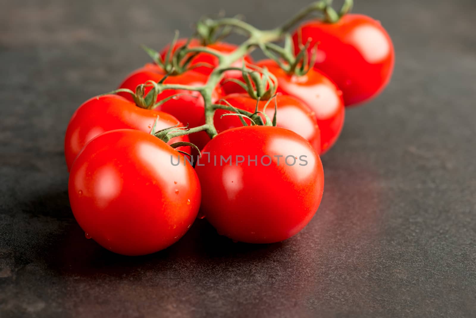 Tomatoes on dark table
