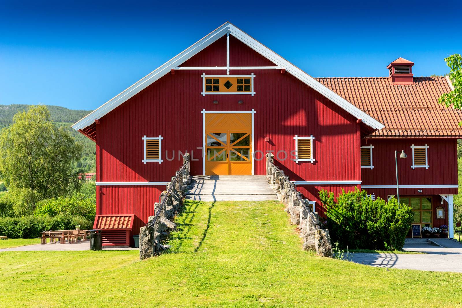 Red wooden house with orange door, barn