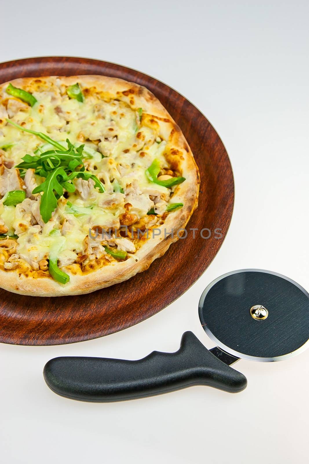 Chicken Pasta on Tray and Pizza Cutter on white by jaaske