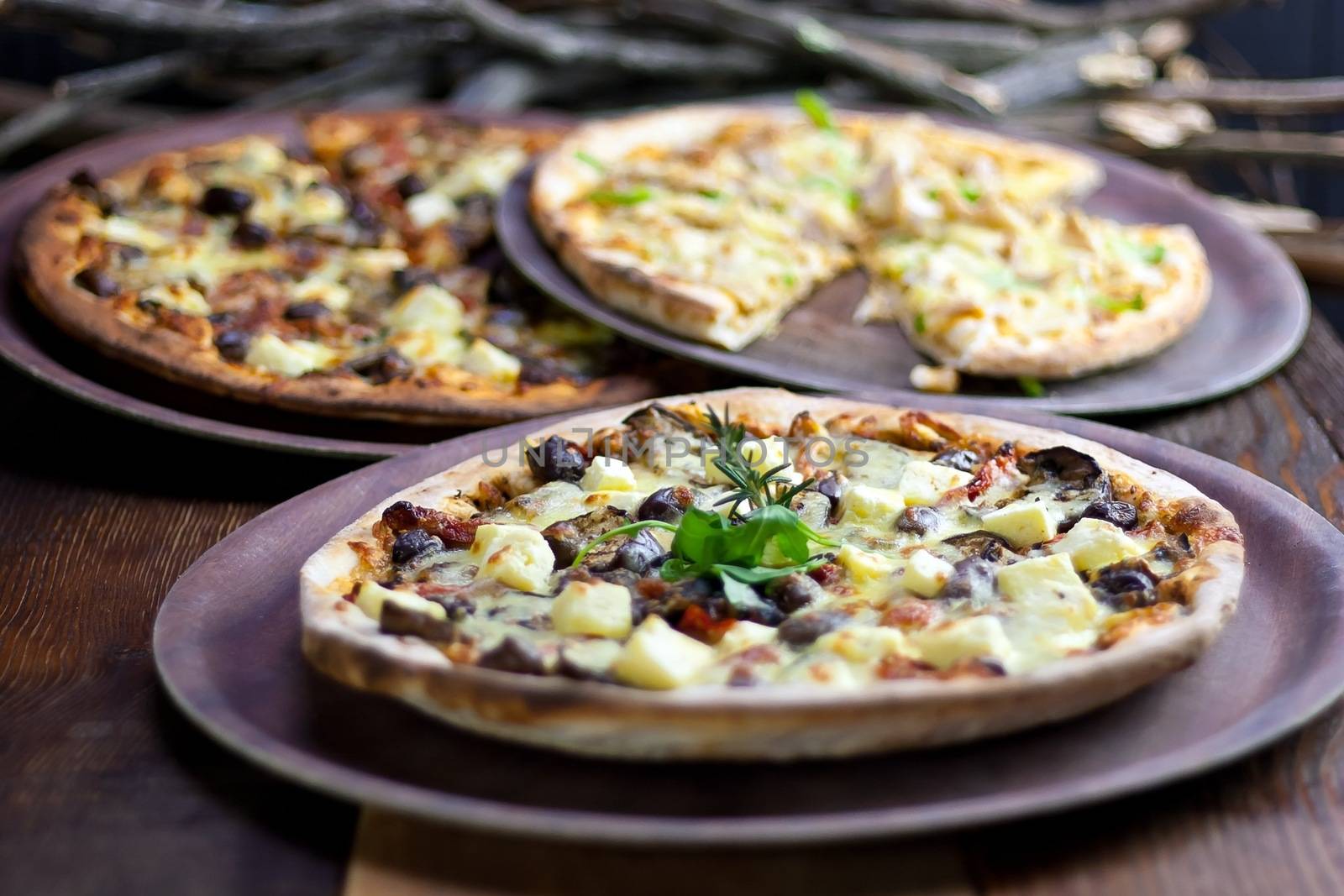 Rustic Pizzas on Table by jaaske