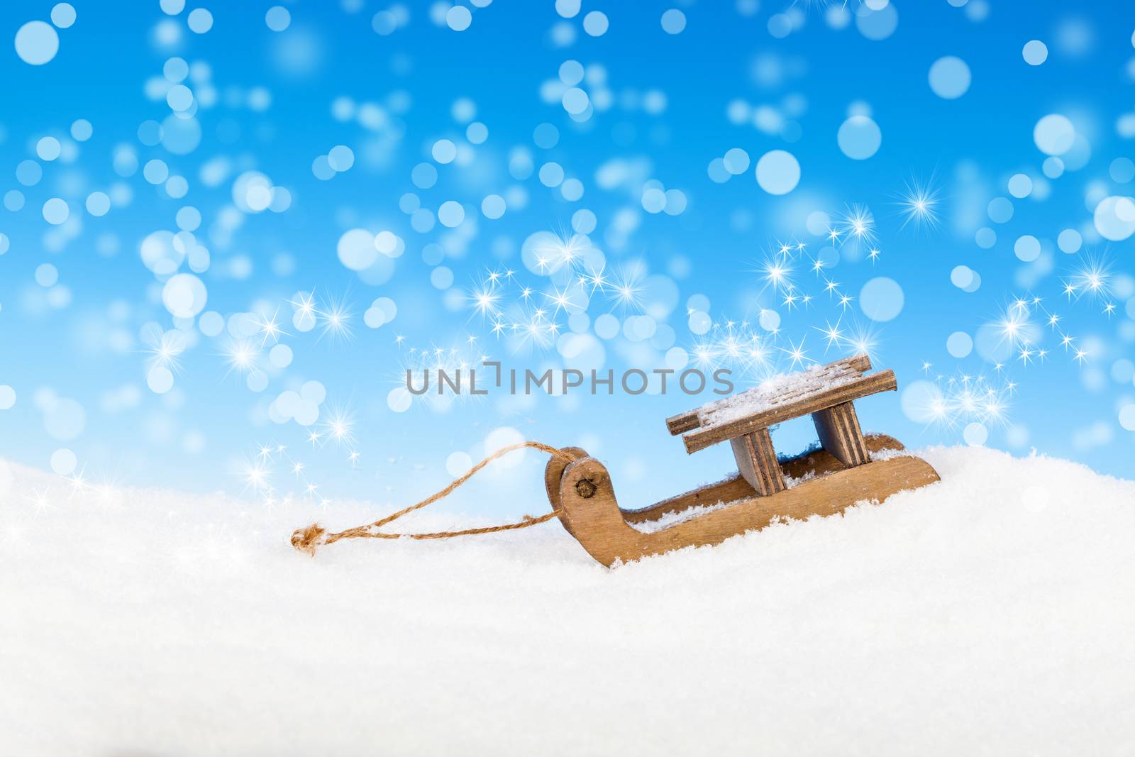 Old vintage wooden sled on blue background