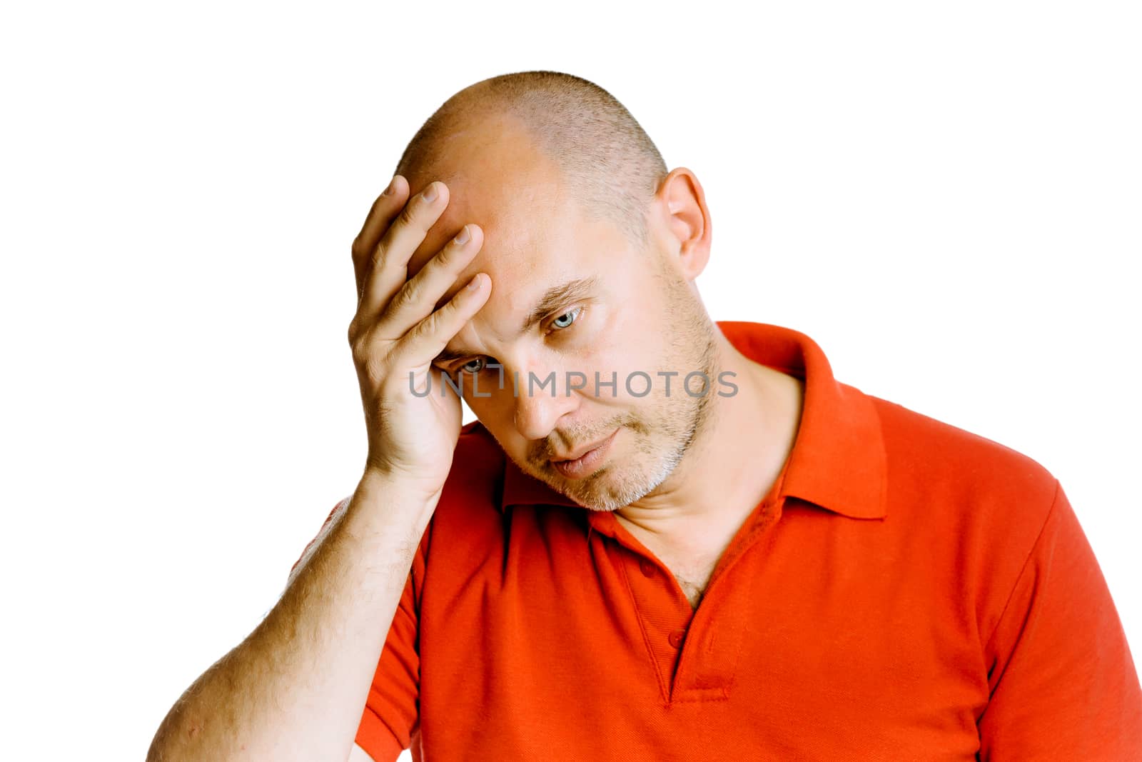 Unshaven blue eyed middle-aged man holding his head. Headache. Studio. isolated