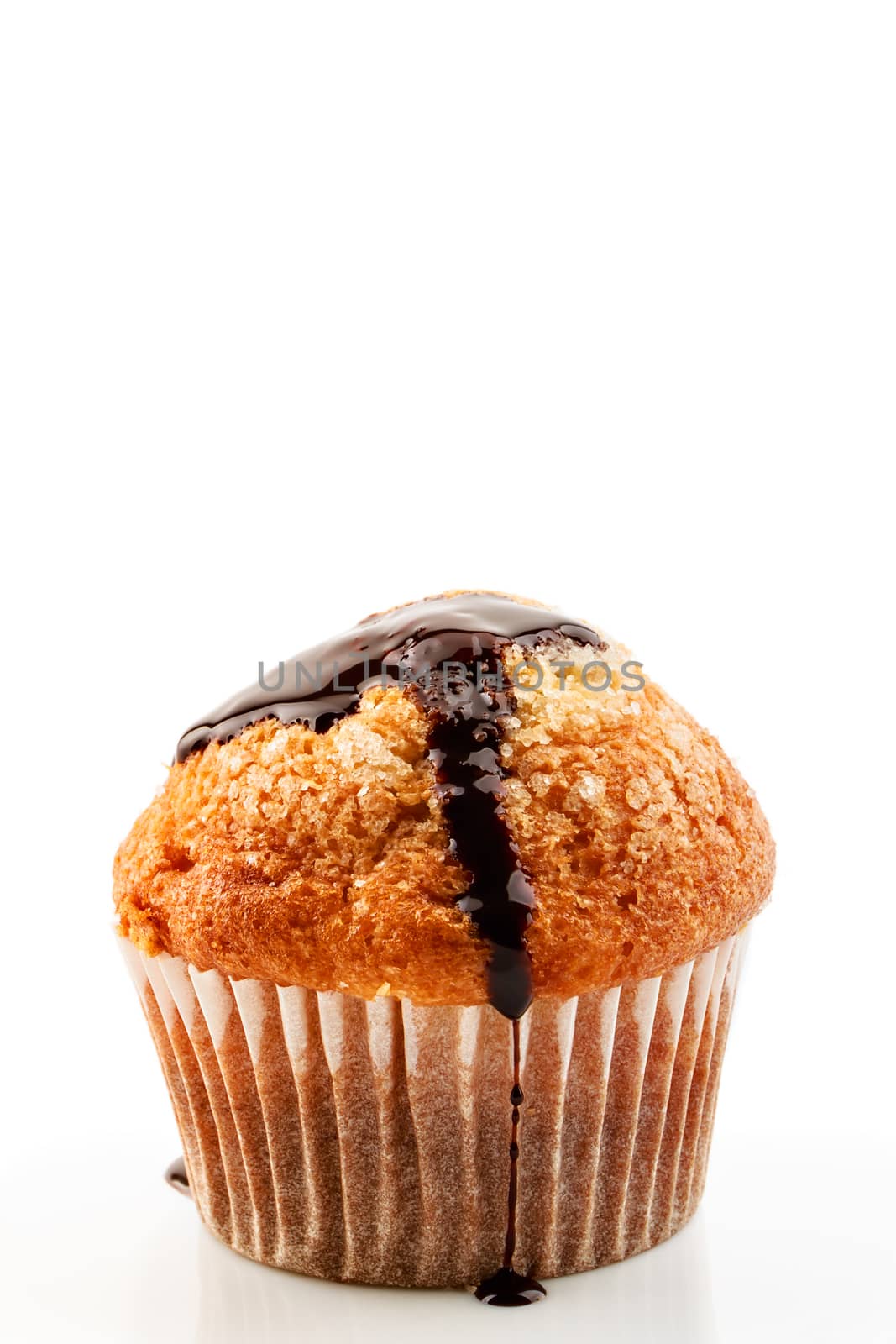 Homemade muffin with liquid chocolate on white background.Vertical image