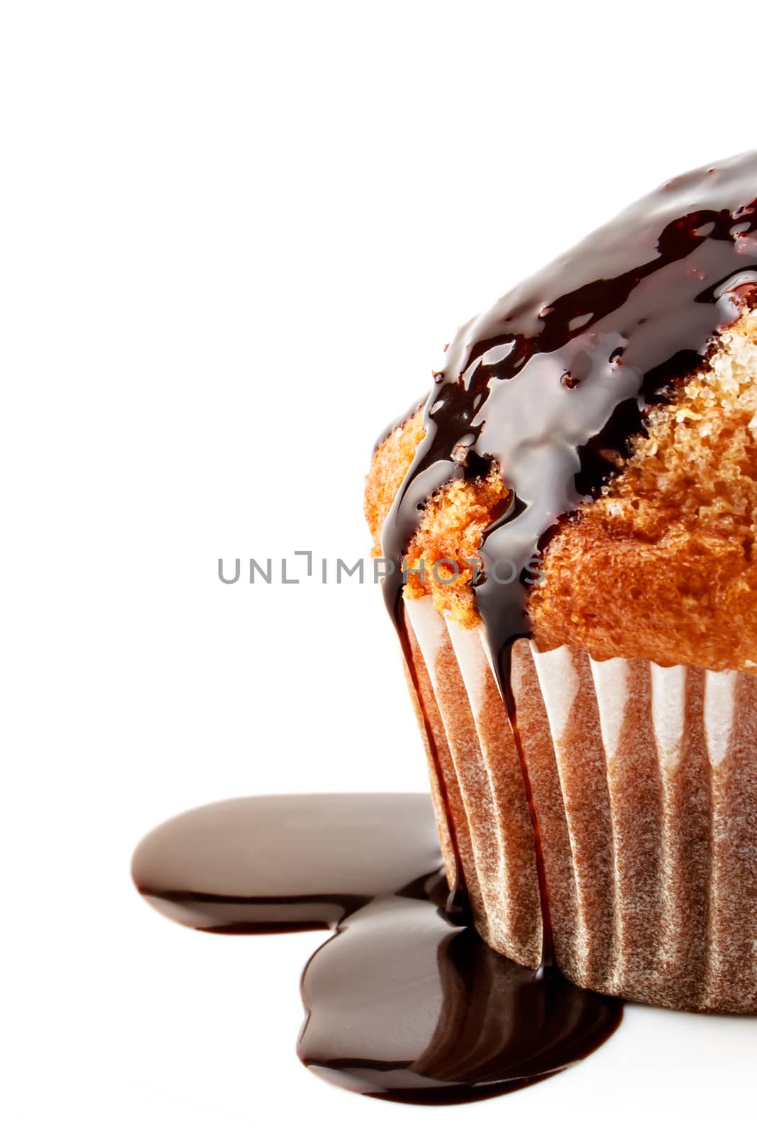 Homemade muffin with liquid chocolate on white background.Vertical image