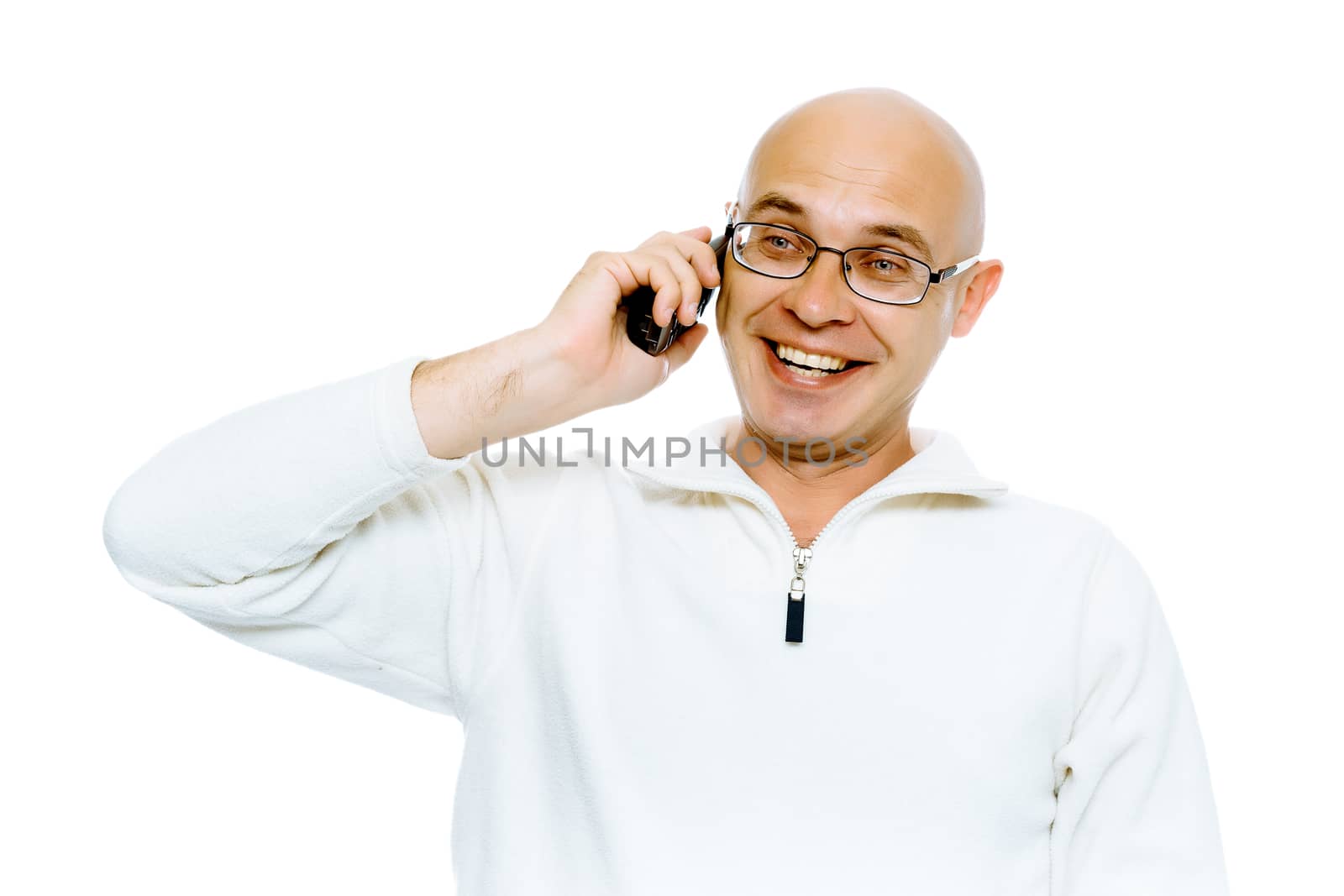 Bald smiling man in glasses speaking by phone. Studio. isolated